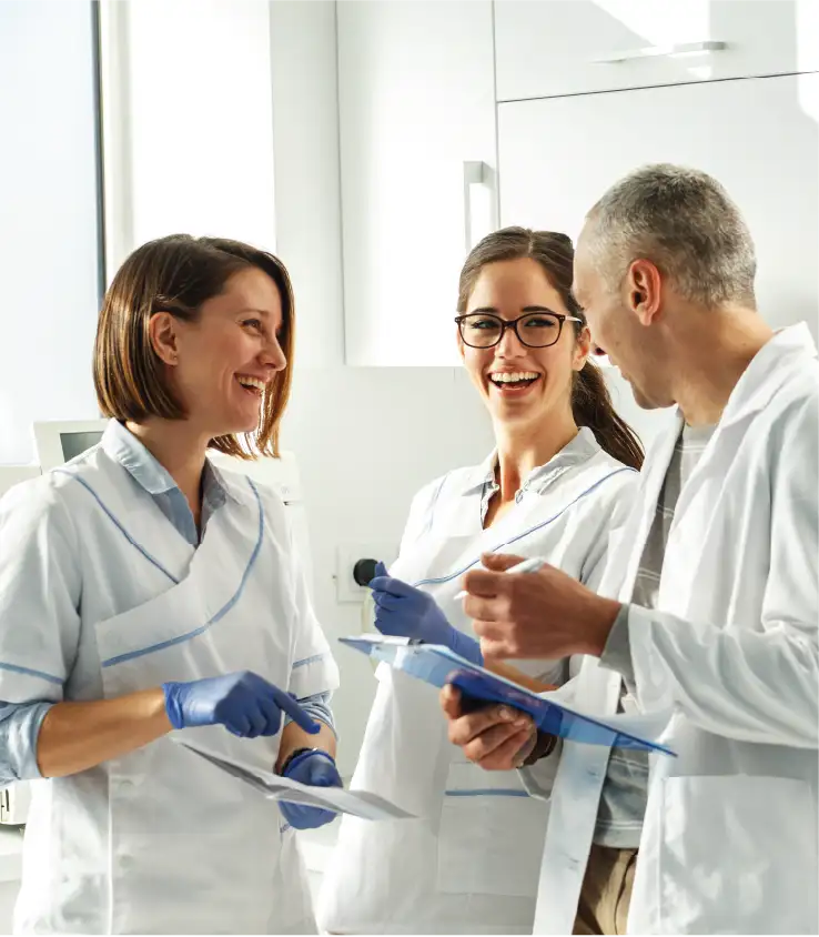 Dental team laughing and smiling
