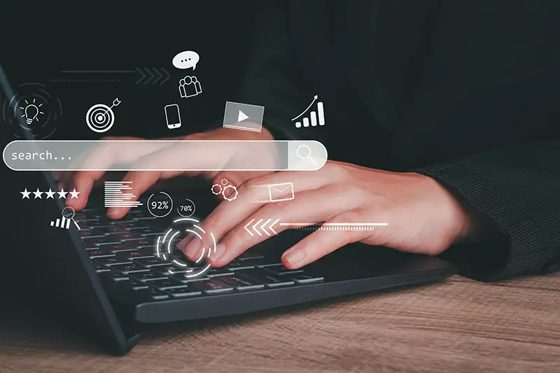 Hands typing on a laptop using a search engine Hands typing on a laptop using a search engine