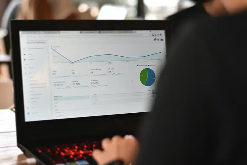 Person on laptop viewing website analytics Person on laptop viewing website analytics