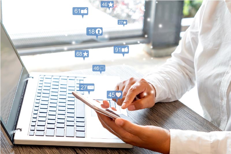 Person clicking on social media icons on computer